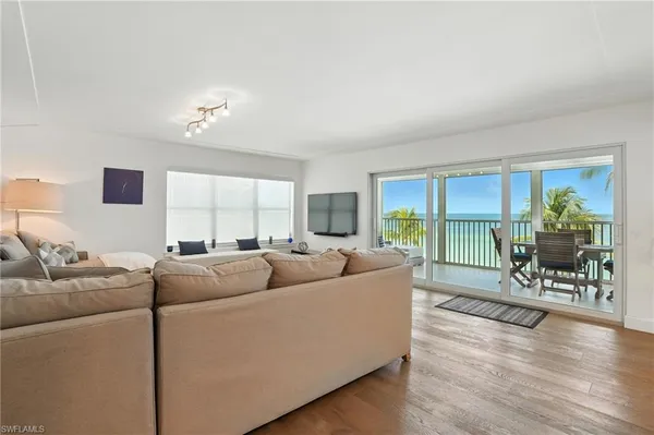 a living room with furniture and a wooden floor