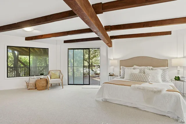 a spacious bedroom with a bed and large window