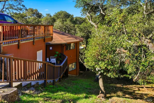 a view of a roof deck with wooden fence and plants
