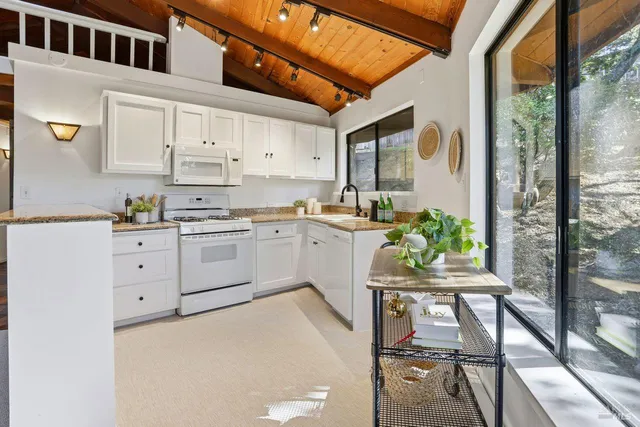 a kitchen with cabinets a sink and appliances in it