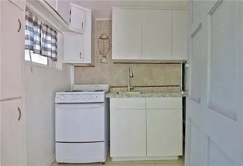 a bathroom with a granite countertop sink a mirror and vanity