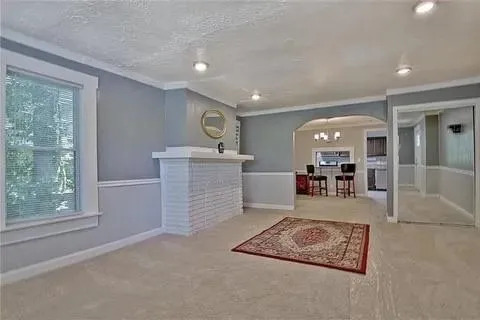 a living room with furniture and a chandelier