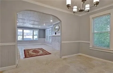 a view of living room with a chandelier and fireplace