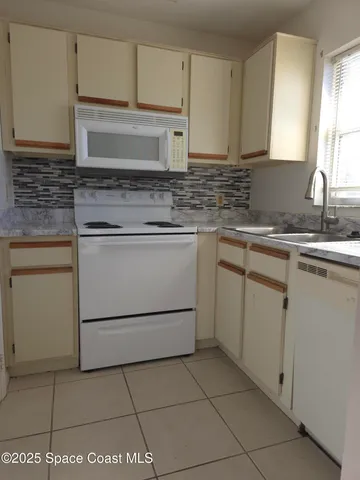 a kitchen with cabinets stainless steel appliances and sink