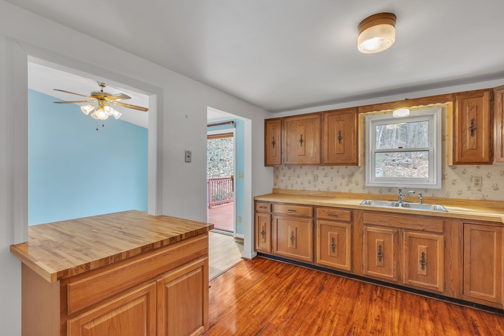 14 Union Road Holland, MA 01521 - Photo 12 of 40 a kitchen with granite countertop white cabinets and wooden floor