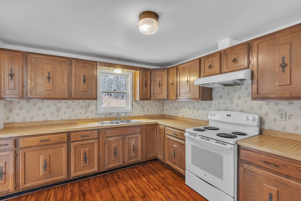 14 Union Road Holland, MA 01521 - Photo 13 of 40 a kitchen with sink cabinets and window