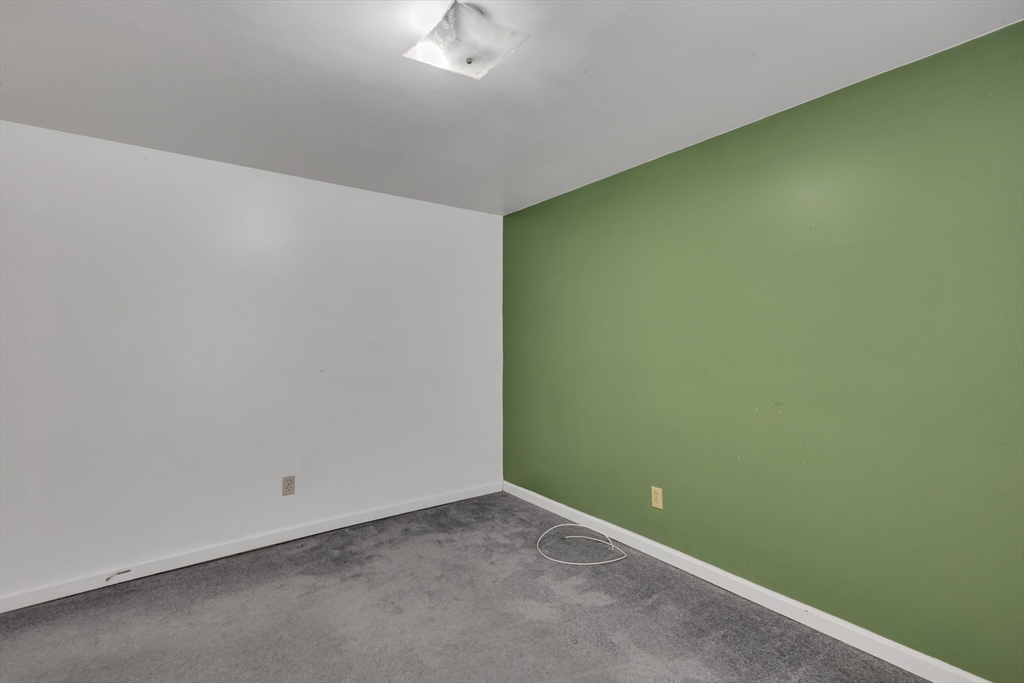 14 Union Road Holland, MA 01521 - Photo 21 of 40 an empty room with a workbench