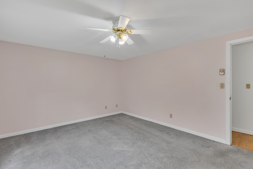 14 Union Road Holland, MA 01521 - Photo 25 of 40 an empty room with a chandelier fan and windows