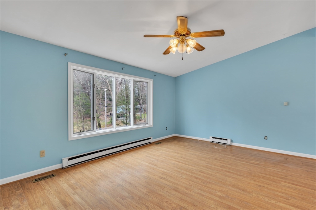 14 Union Road Holland, MA 01521 - Photo 3 of 40 a view of an empty room with a window and wooden floor