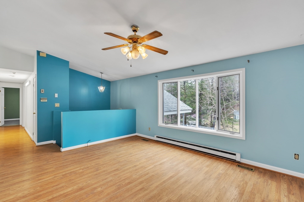 14 Union Road Holland, MA 01521 - Photo 5 of 40 a view of an empty room with window and wooden floor