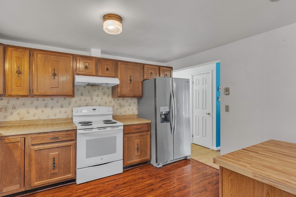 14 Union Road Holland, MA 01521 - Photo 10 of 40 a kitchen with a stove and a refrigerator