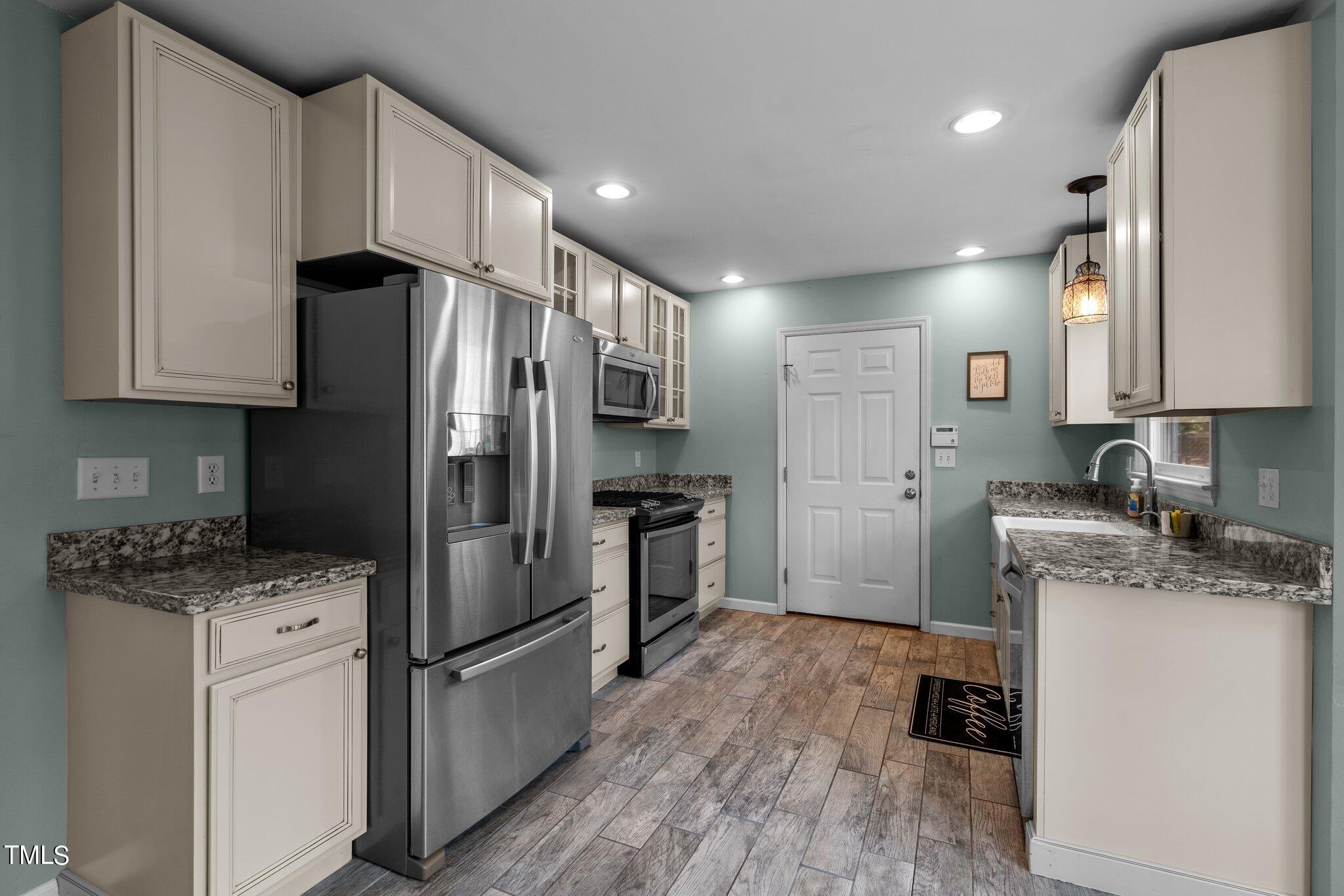 5315 Middleton Road Durham, NC 27713 - Photo 7 of 22 a kitchen with stainless steel appliances granite countertop a refrigerator stove a sink and dishwasher