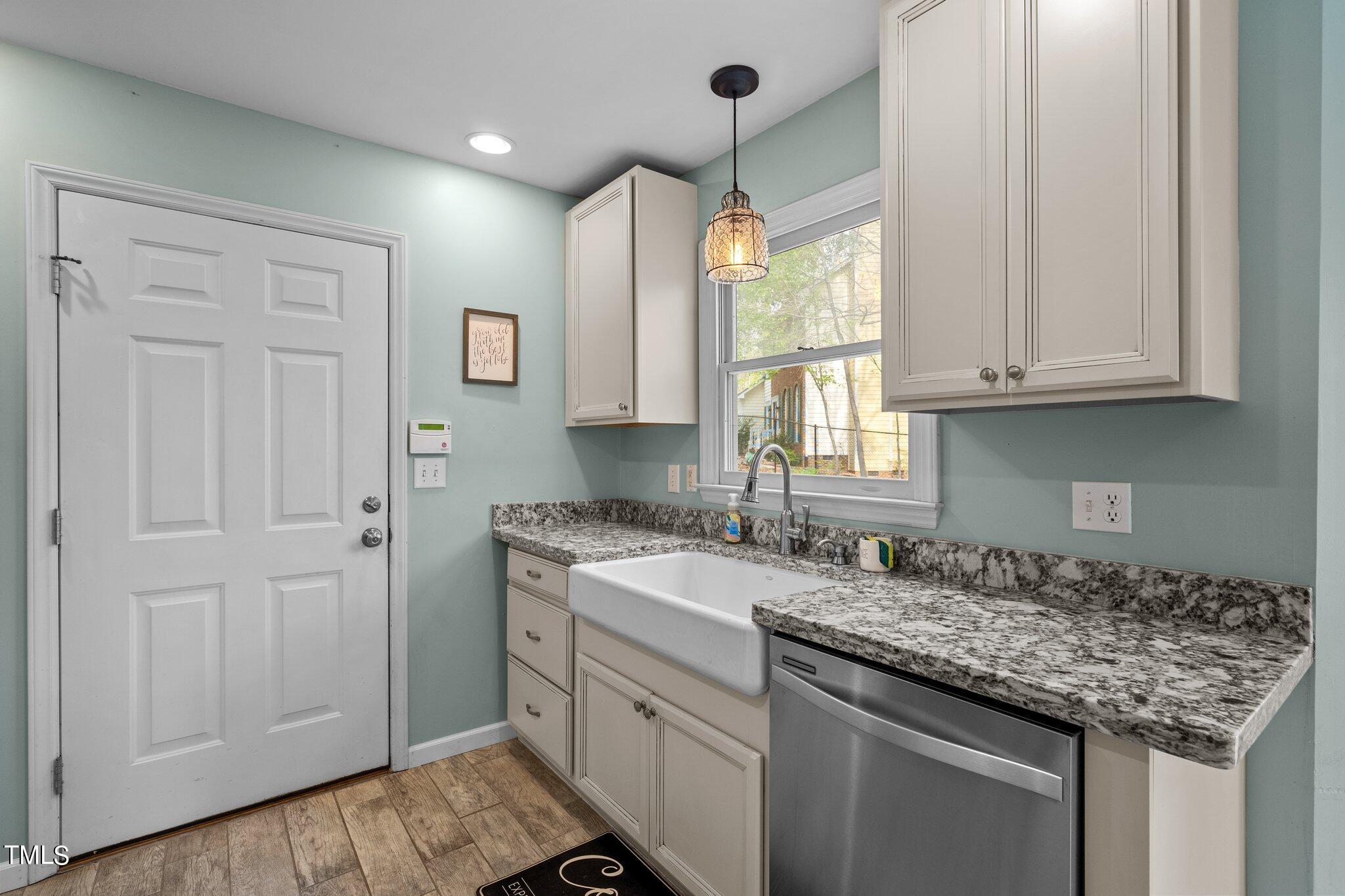 5315 Middleton Road Durham, NC 27713 - Photo 8 of 22 a kitchen with a sink stove and cabinets