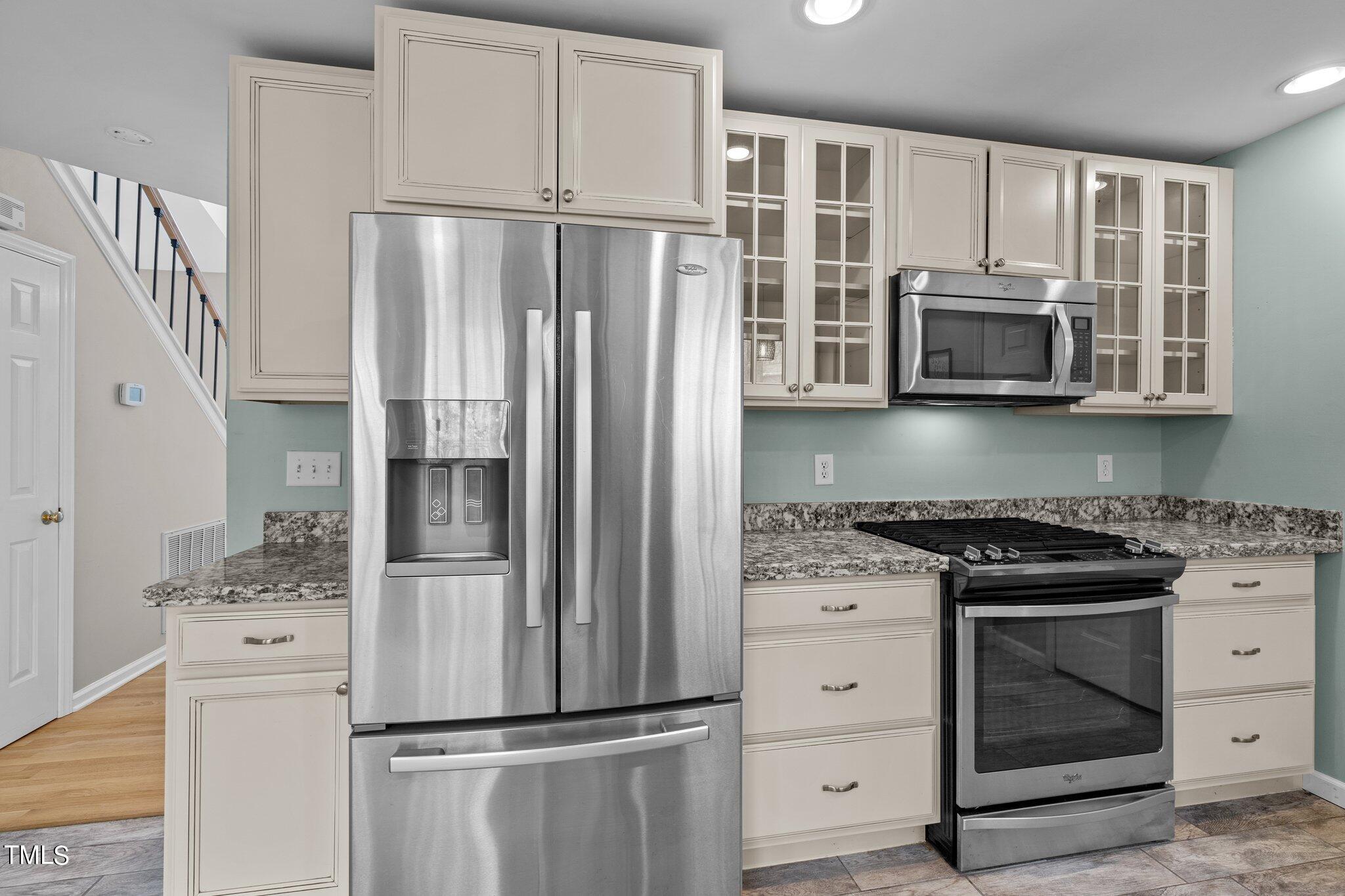 5315 Middleton Road Durham, NC 27713 - Photo 9 of 22 a kitchen with stainless steel appliances white cabinets and a stove top oven