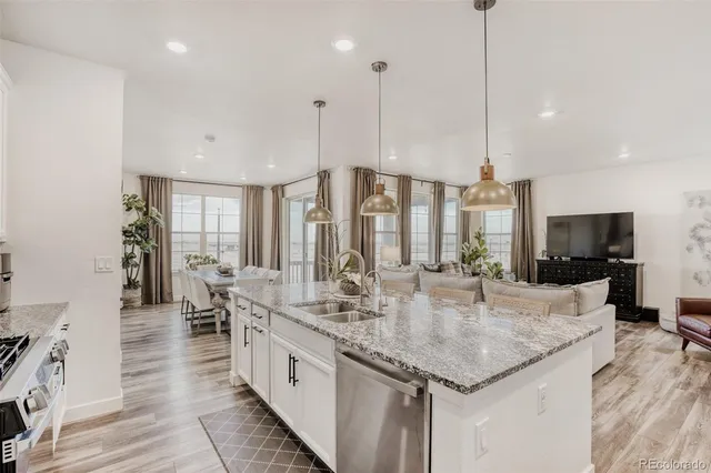 a kitchen with center island and a view of living room