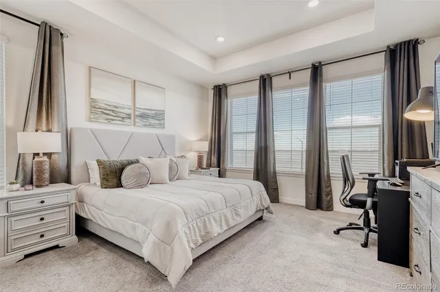 a bedroom with a bed furniture and a large window