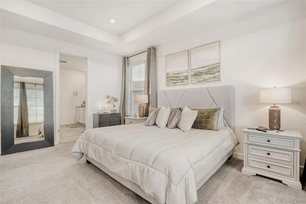 a bedroom with a bed and a night stand