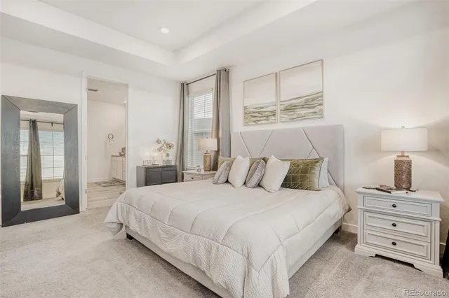 a bedroom with a bed and a night stand