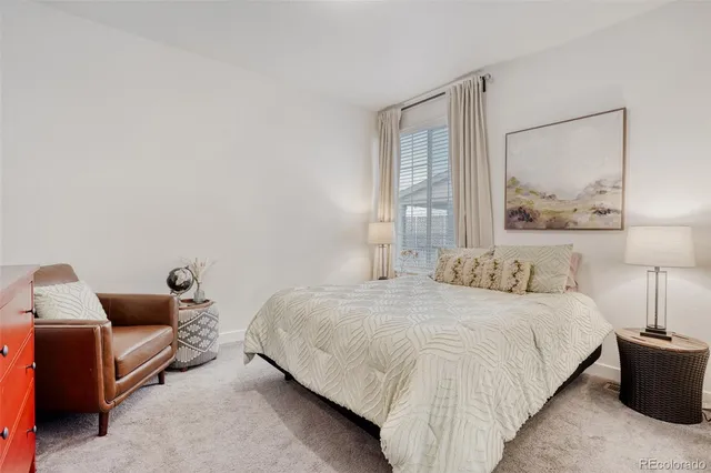 a bedroom with a bed and lamp