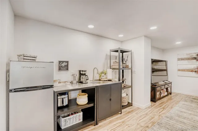 a kitchen with stainless steel appliances granite countertop a refrigerator and a sink