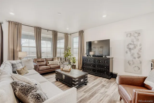 a living room with furniture and large windows