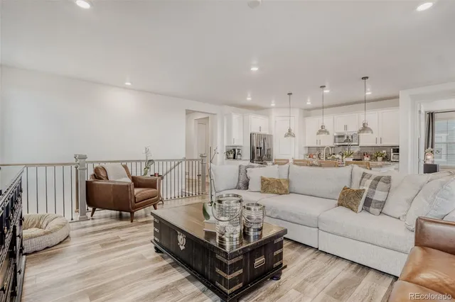 a living room with furniture white walls and wooden floor