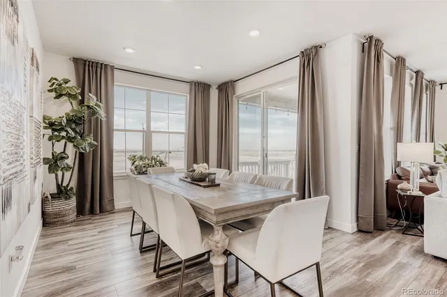 a view of a dining room with furniture and a window