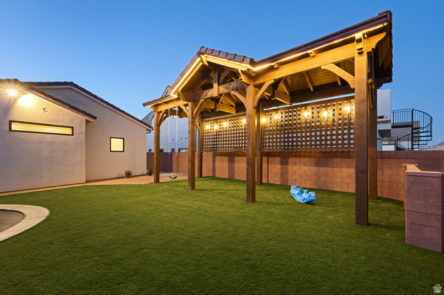 4871 South Homestead Way Washington, UT 84780 - Photo 115 of 151 Yard at dusk featuring a fenced backyard and a patio
