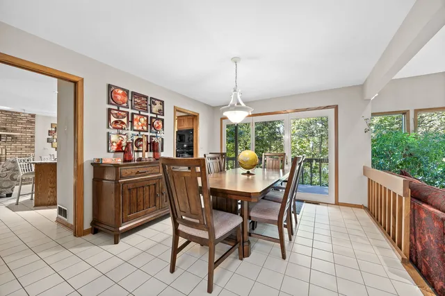 a dining room with furniture a chandelier and window