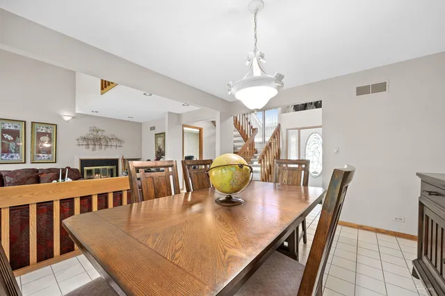 a view of a dining room with furniture and a chandelier