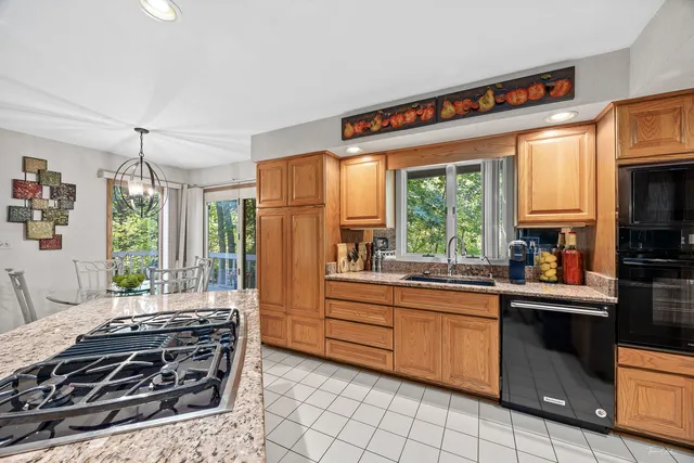 a kitchen with a stove a sink and a refrigerator