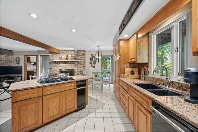 a kitchen with stainless steel appliances granite countertop sink stove and cabinets