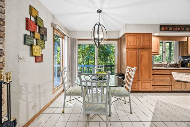 a dining room with furniture and large windows
