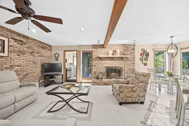 a living room with furniture a fireplace and a flat screen tv