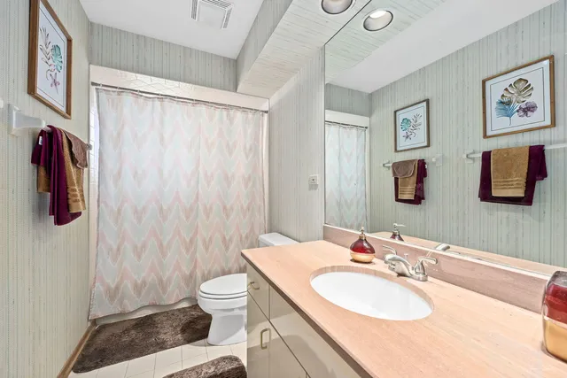 a spacious bedroom with a bed a couch and a window