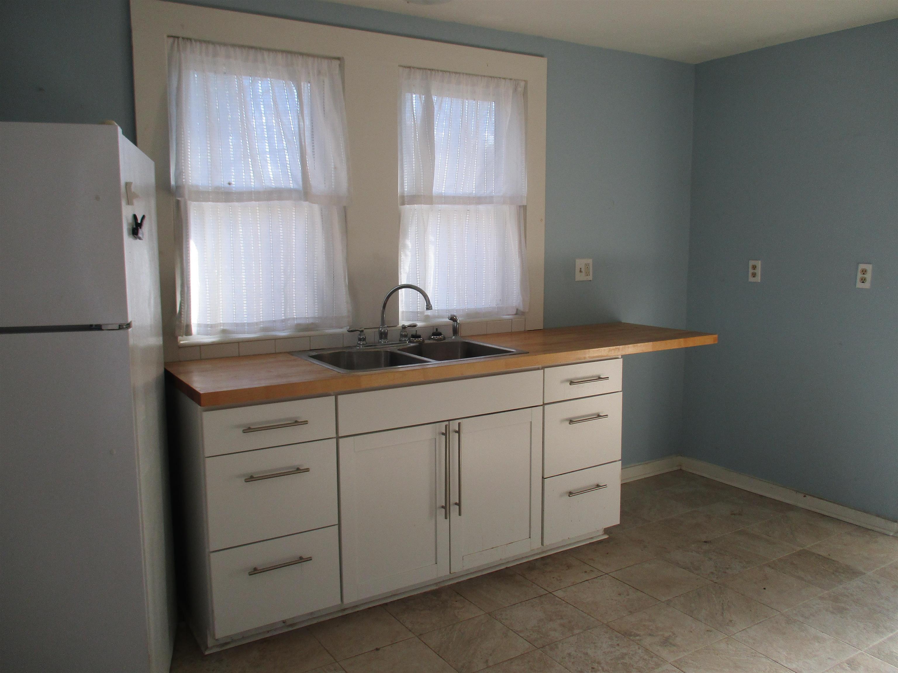 4057 Oak Ridge Road Mount Crawford, VA 22841 - Photo 11 of 38 a room with white cabinets and a refrigerator