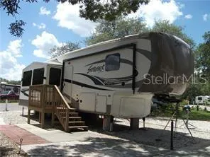 a view of a chairs and table in the roof deck