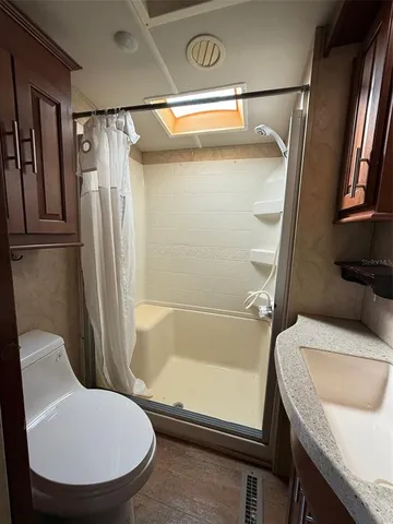 a bathroom with a sink toilet and shower