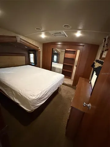 a bedroom with a bed and a mirror