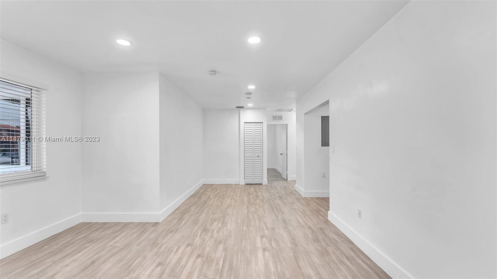 West Flagler Miami, FL 33125 - Photo 15 of 37 a view of a big room with wooden floor and windows