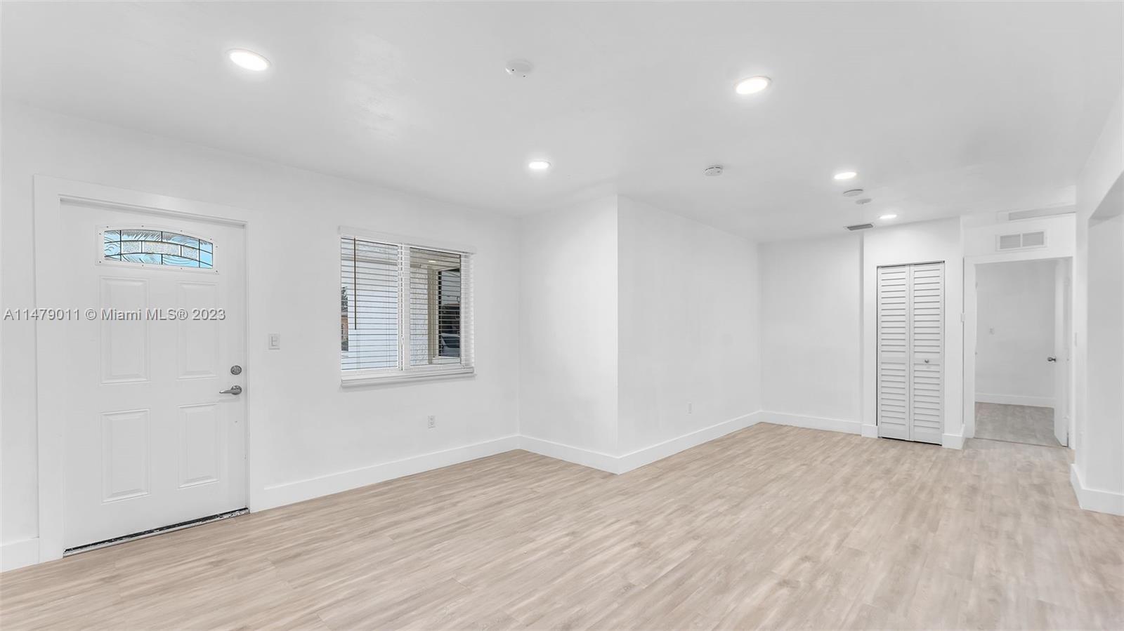 West Flagler Miami, FL 33125 - Photo 16 of 37 an empty room with wooden floor and windows