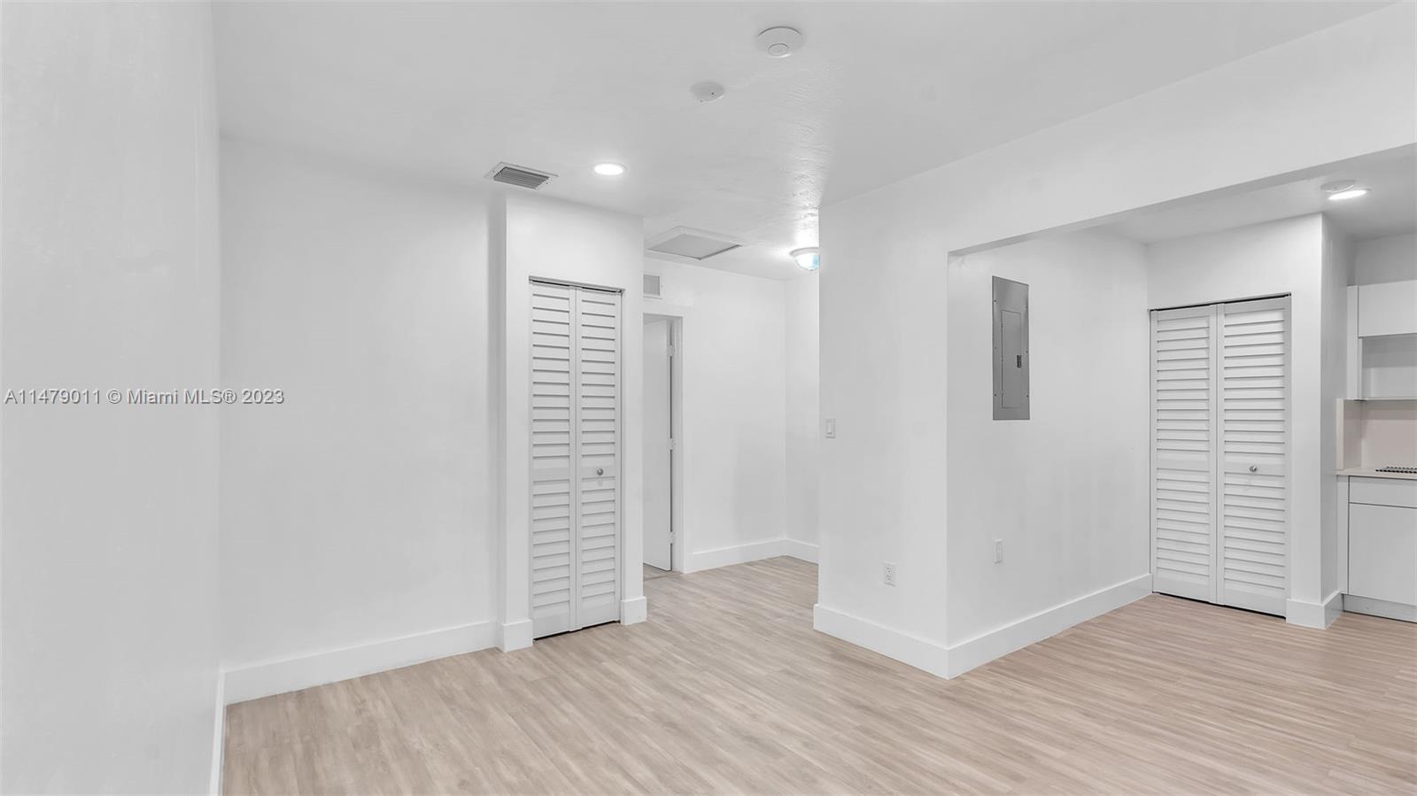 West Flagler Miami, FL 33125 - Photo 19 of 37 wooden floor in an empty room with a window
