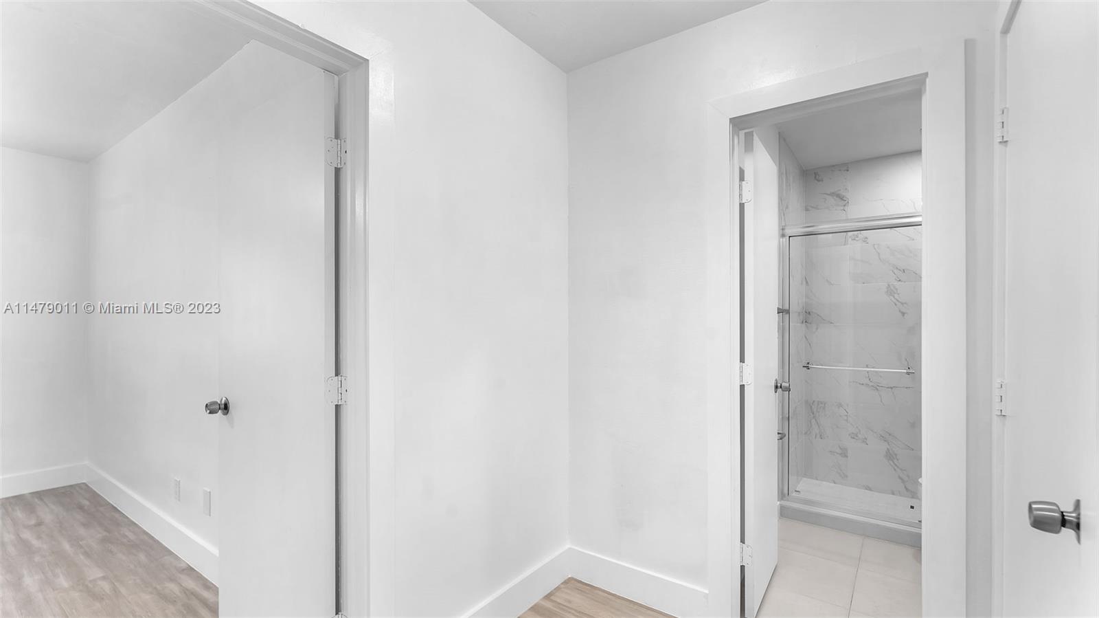 West Flagler Miami, FL 33125 - Photo 23 of 37 a bathroom with a glass shower door