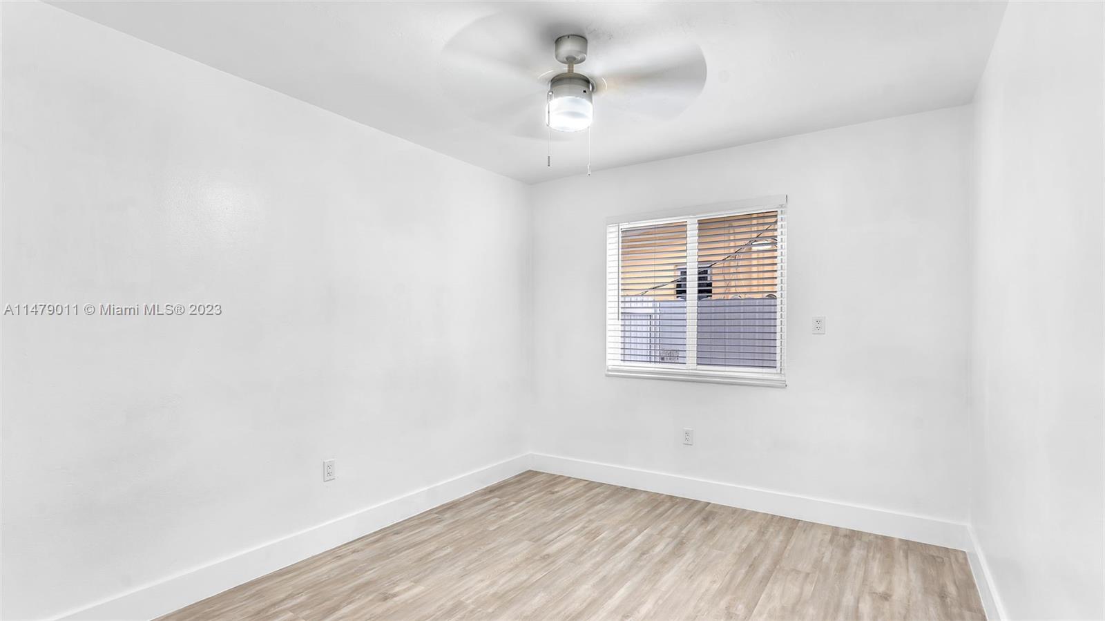 West Flagler Miami, FL 33125 - Photo 24 of 37 an empty room with wooden floor and windows