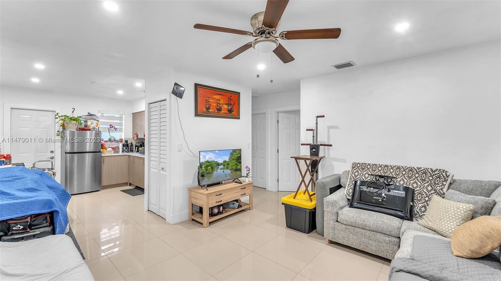 West Flagler Miami, FL 33125 - Photo 3 of 37 a living room with furniture and a chandelier