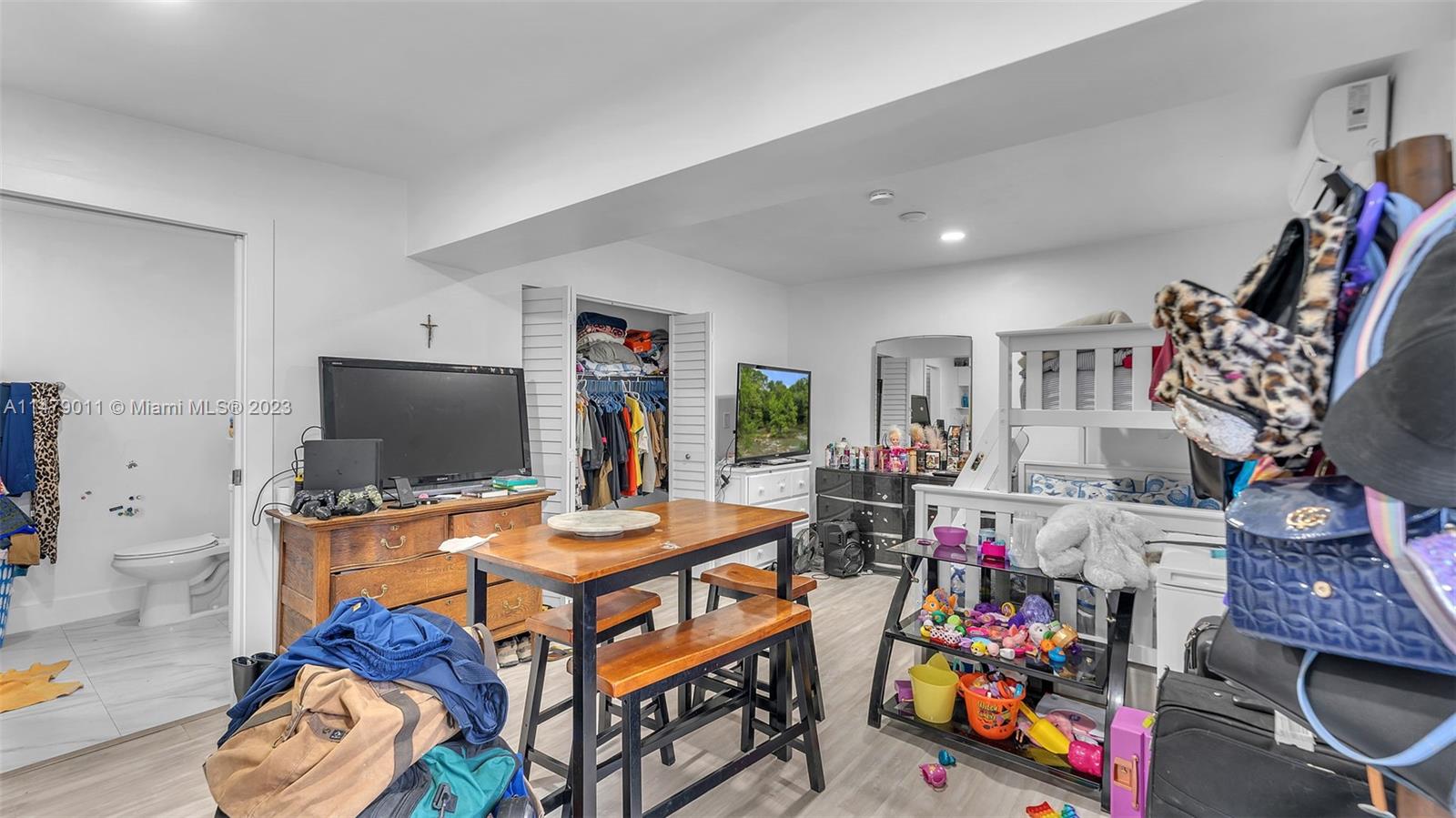 West Flagler Miami, FL 33125 - Photo 32 of 37 a room with furniture a flat screen tv and a window