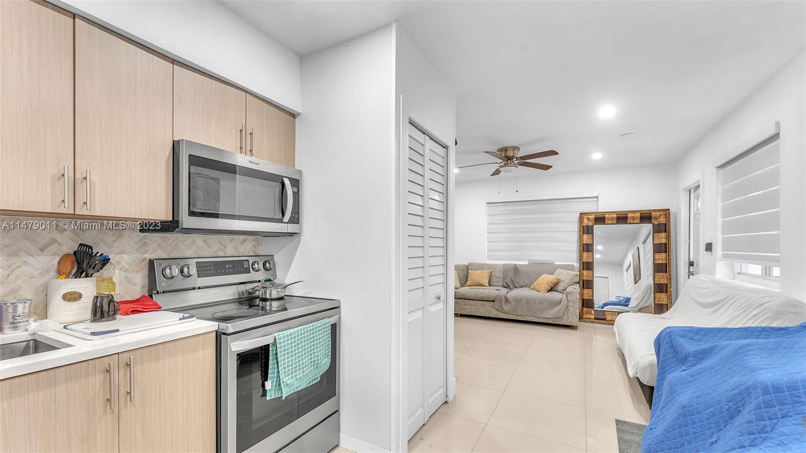 West Flagler Miami, FL 33125 - Photo 5 of 37 a kitchen with stainless steel appliances granite countertop a stove and a sink