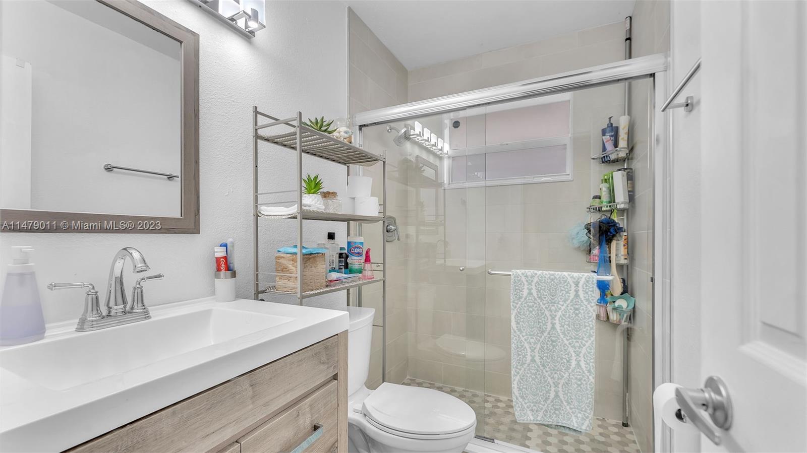 West Flagler Miami, FL 33125 - Photo 7 of 37 a bathroom with a sink vanity mirror and toilet