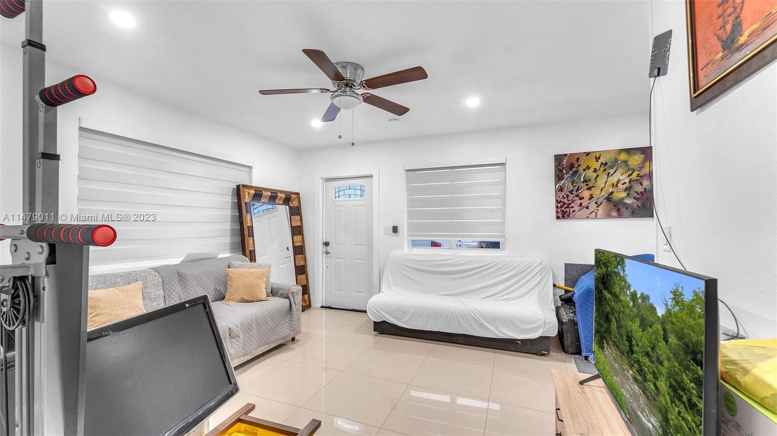 West Flagler Miami, FL 33125 - Photo 9 of 37 a bedroom with furniture and a large window