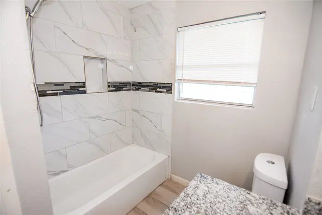 a bathroom with a bathtub and a toilet